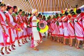 Karma folk dancers in traditional white sarees with red borders